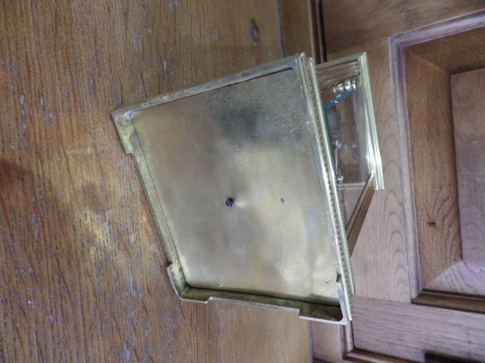 A late nineteenth-century French gilt brass repeating carriage clock featuring glass panels, a carrying handle, and a dial with Roman numerals. View VIII