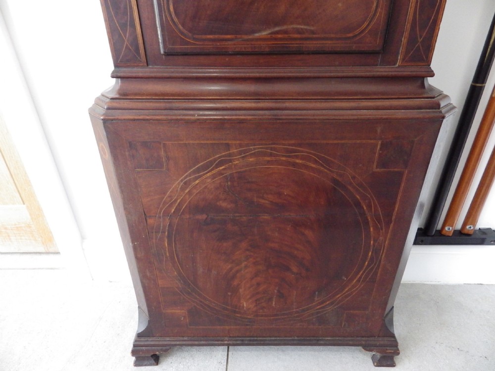 A late 18th-century Georgian mahogany longcase clock featuring a swan-neck pediment and an arched painted dial with moon phase function. View II