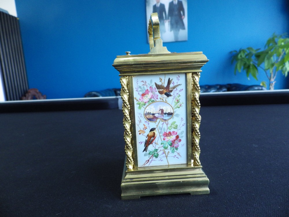 A late 19th-century French gilt brass repeating carriage clock featuring rope-twist columns and a light blue enamel dial panel decorated with painted birds and floral motifs. View II