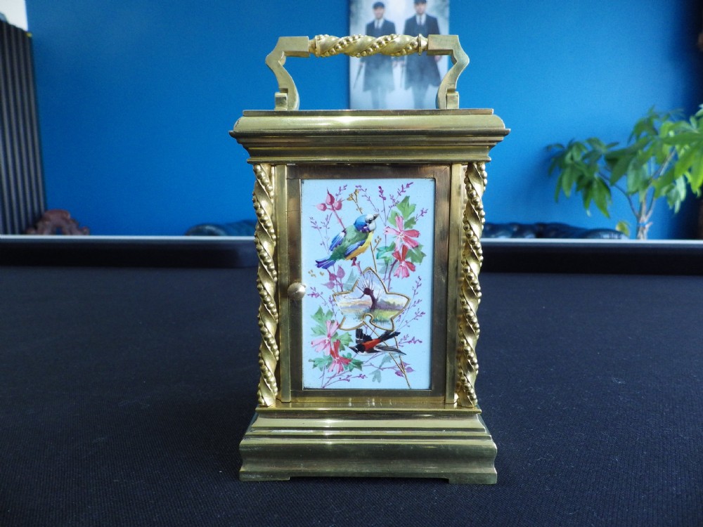 A late 19th-century French gilt brass repeating carriage clock featuring rope-twist columns and a light blue enamel dial panel decorated with painted birds and floral motifs. View III