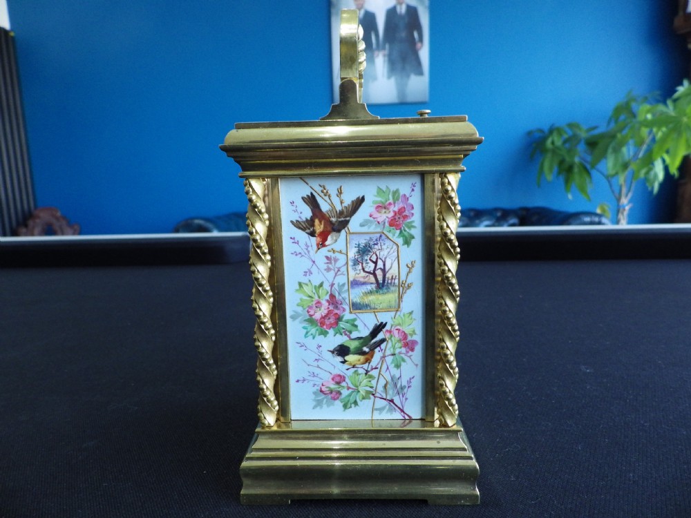 A late 19th-century French gilt brass repeating carriage clock featuring rope-twist columns and a light blue enamel dial panel decorated with painted birds and floral motifs. View IV