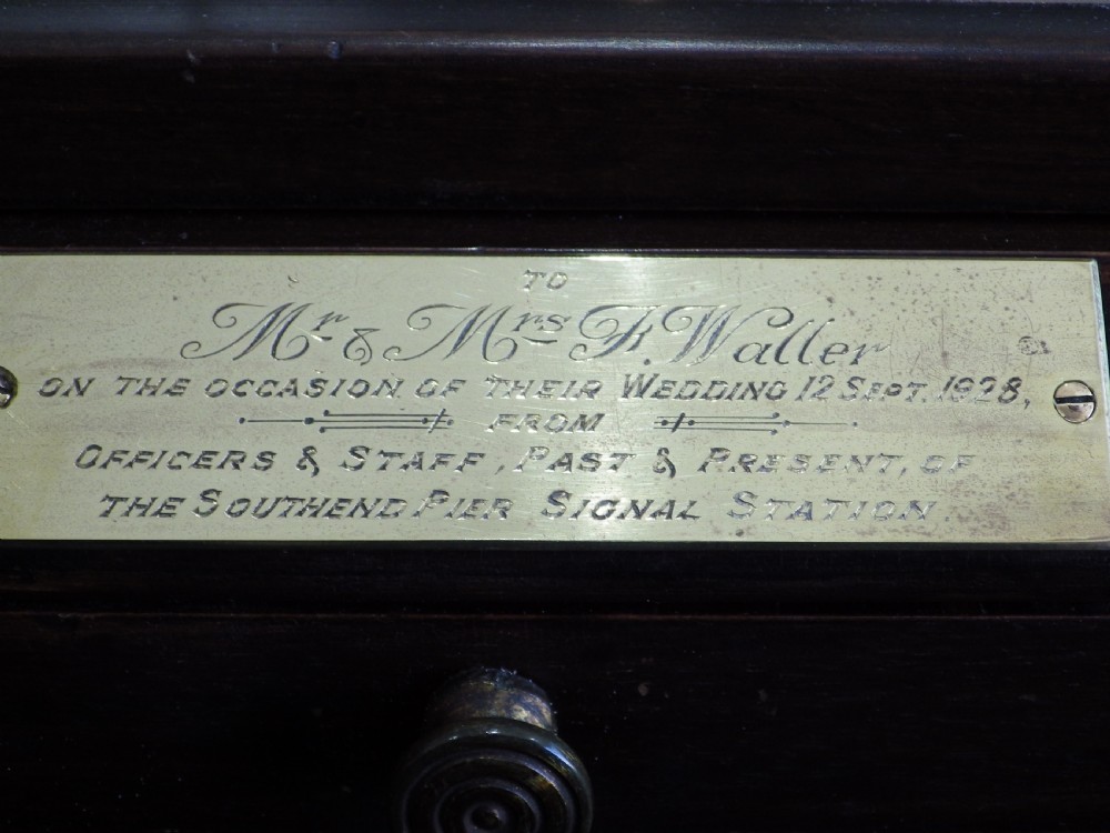 A 1920s mahogany and glass barograph featuring brass internal mechanisms, an aneroid capsule stack, and an engraved brass presentation plaque on the drawer base. View III