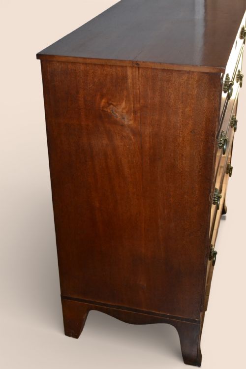 fig 1. A Georgian flame mahogany chest of four graduated drawers with brass ring handles and splayed bracket feet.