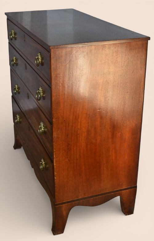 fig 2. A Georgian flame mahogany chest of four graduated drawers with brass ring handles and splayed bracket feet.