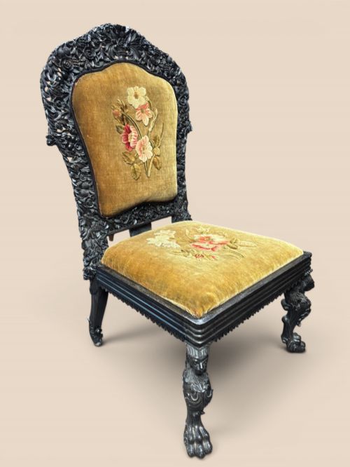 fig 1. Late 19th-century Anglo-Indian ebony side chair featuring intricate hand-carved floral backrest detailing and floral needlepoint velvet seat.