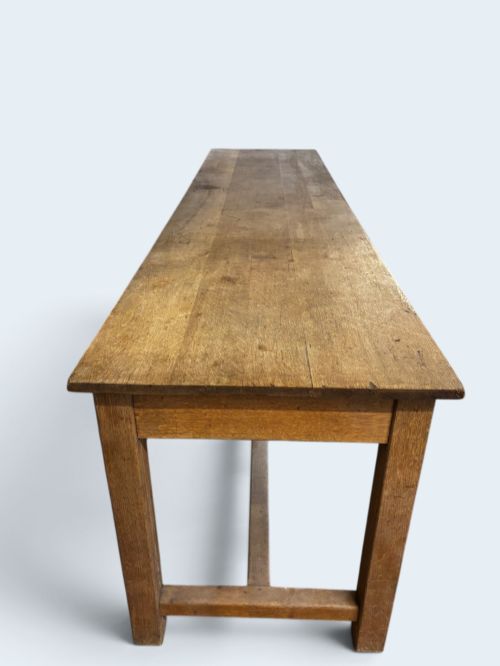 fig 1. An exceptionally long rustic solid oak serving table featuring dual apron drawers, square legs, and a low central stretcher.