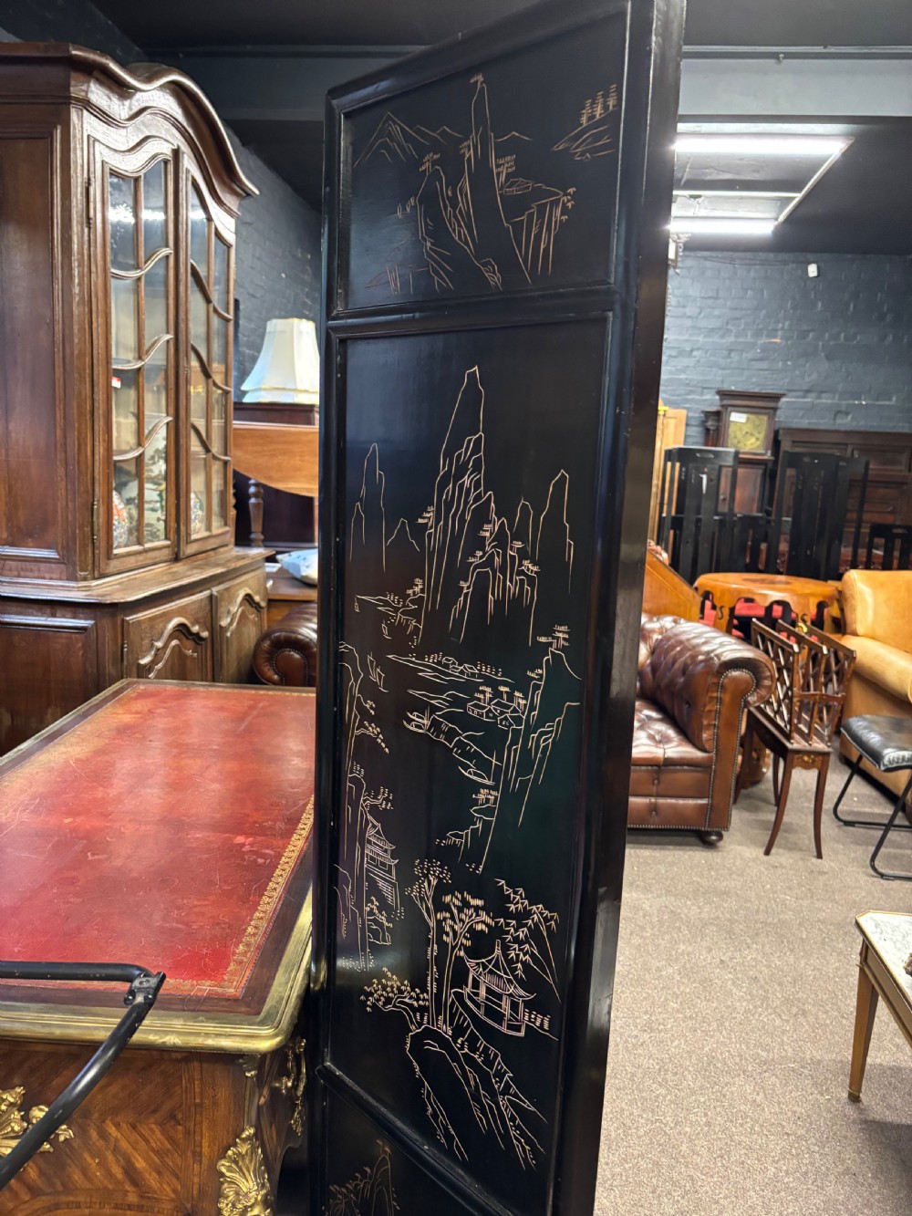 A six-panel black lacquered folding screen featuring raised stone inlays of birds and flowering branches with pierced fretwork lower panels. View VI