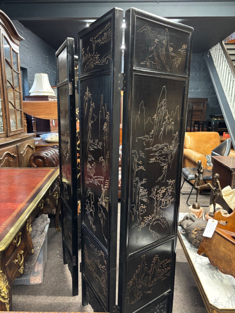 A six-panel black lacquered folding screen featuring raised stone inlays of birds and flowering branches with pierced fretwork lower panels. View VII