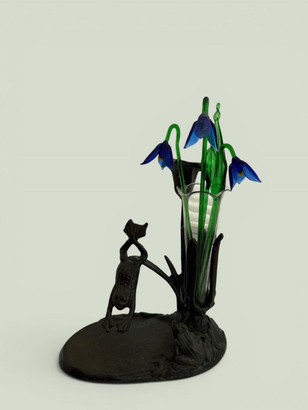 A dark patinated bronze Art Nouveau flower holder featuring sculpted frogs around a lily stem with a clear fluted glass vase liner. View III