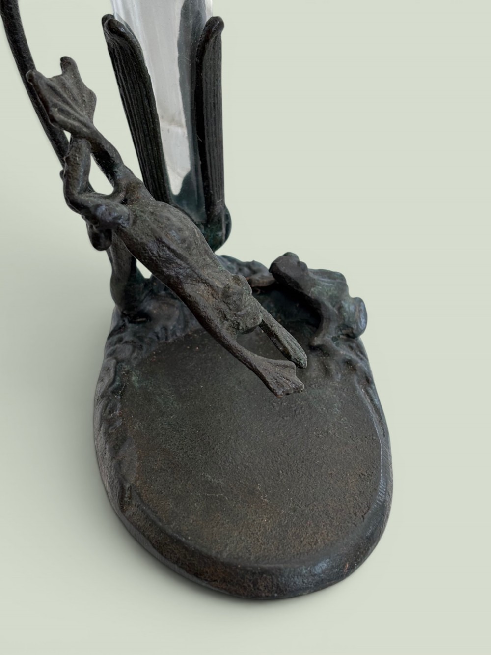 A dark patinated bronze Art Nouveau flower holder featuring sculpted frogs around a lily stem with a clear fluted glass vase liner. View IV