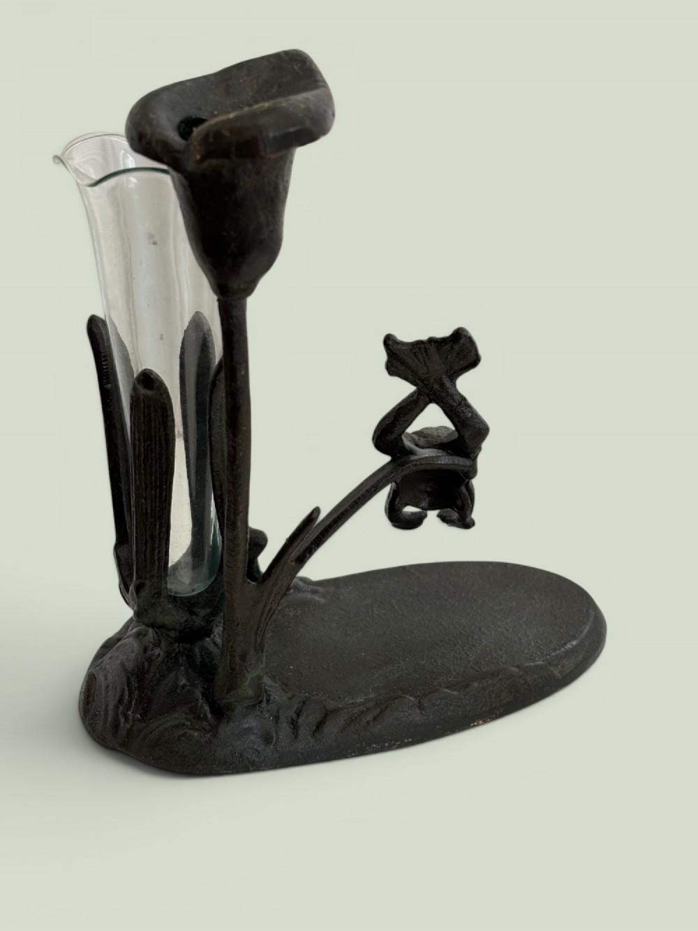 A dark patinated bronze Art Nouveau flower holder featuring sculpted frogs around a lily stem with a clear fluted glass vase liner. View VI