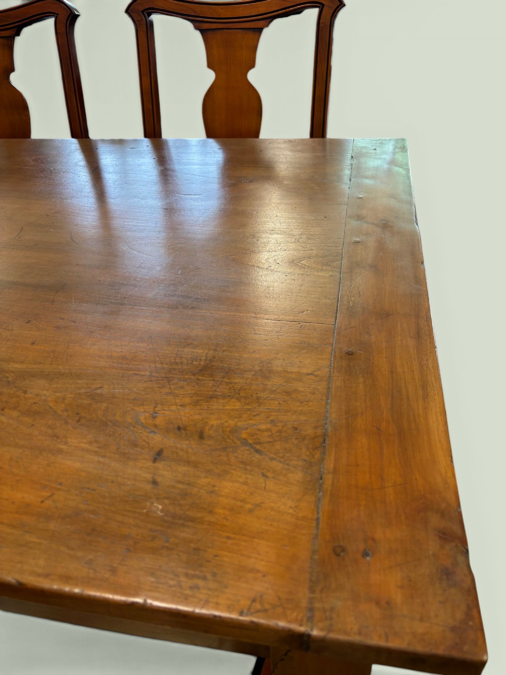 A 19th-century French cherrywood farmhouse table featuring two drawers with iron ring pulls and a sturdy H-stretcher base. View IV