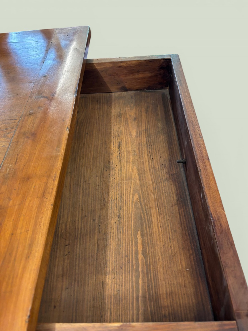 A 19th-century French cherrywood farmhouse table featuring two drawers with iron ring pulls and a sturdy H-stretcher base. View VI