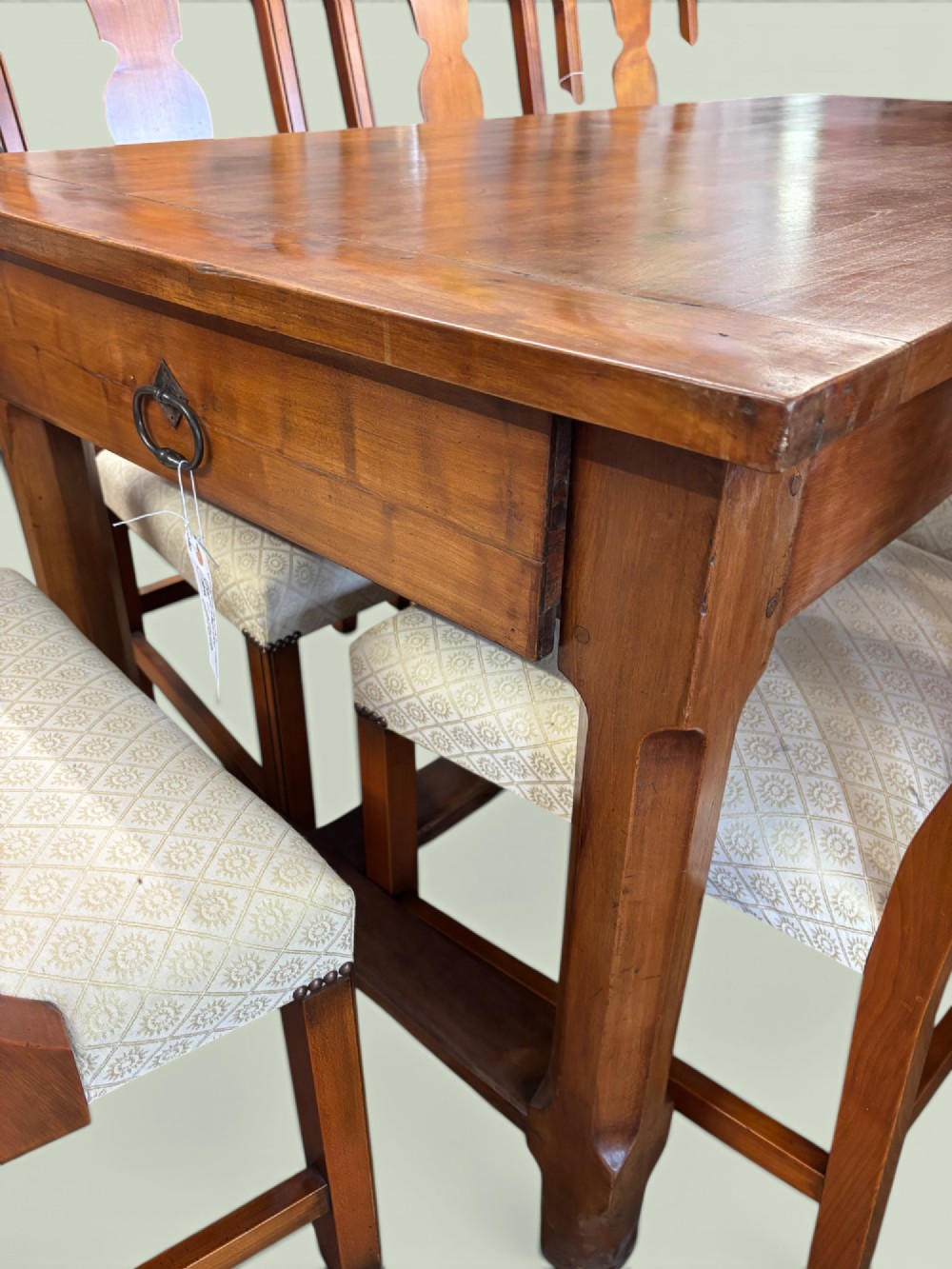 A 19th-century French cherrywood farmhouse table featuring two drawers with iron ring pulls and a sturdy H-stretcher base. View VII