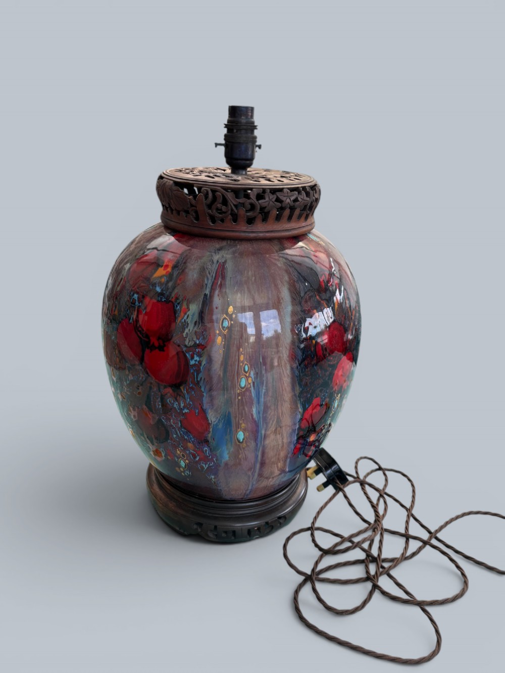 A baluster-shaped Moorcroft art pottery table lamp featuring hand-painted red fruit motifs, high-gloss glaze, and carved wooden mounts. View III