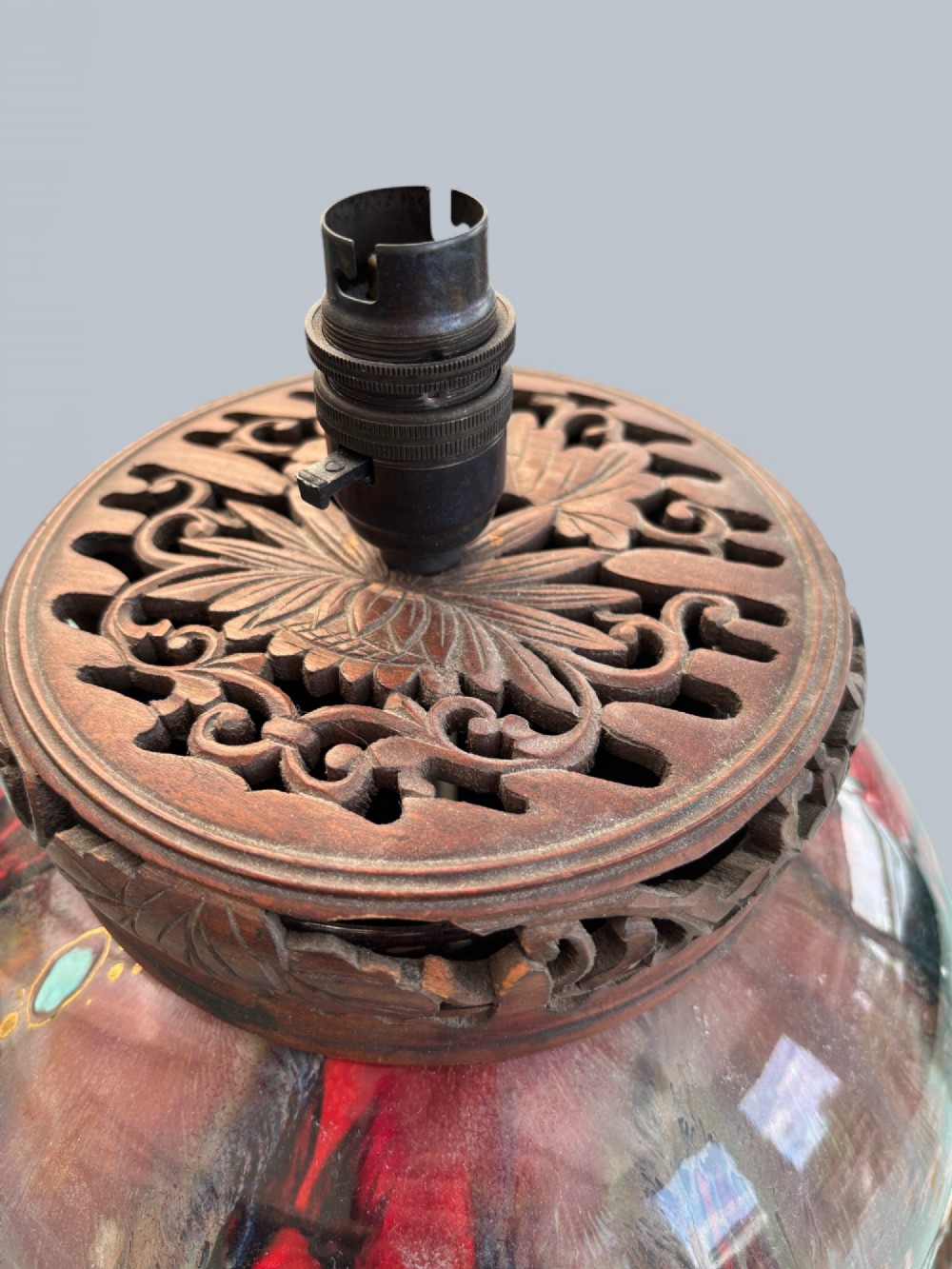 A baluster-shaped Moorcroft art pottery table lamp featuring hand-painted red fruit motifs, high-gloss glaze, and carved wooden mounts. View IV