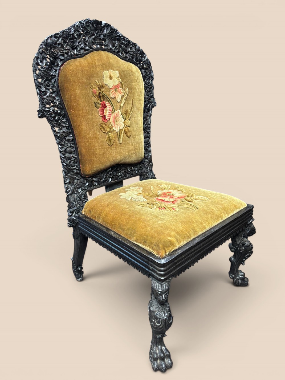 Late 19th-century Anglo-Indian ebony side chair featuring intricate hand-carved floral backrest detailing and floral needlepoint velvet seat. View II