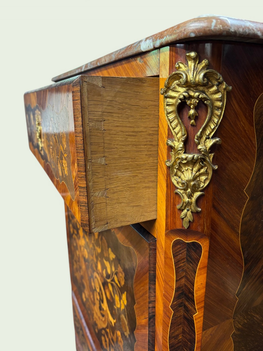 A tall French marquetry secretaire cabinet featuring floral wood inlays, gilt-bronze mounts, four drawers, and a marble top surface. View V