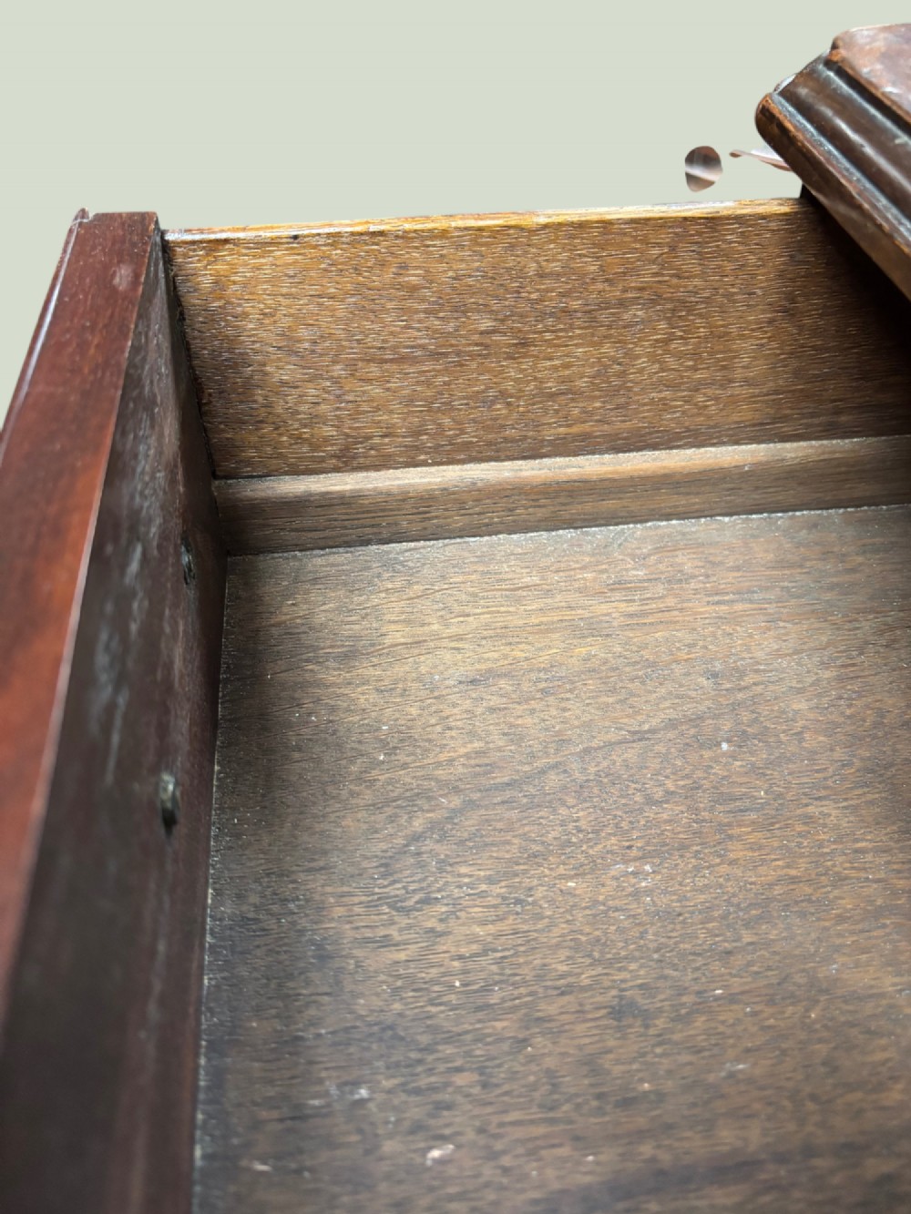 A Georgian mahogany kneehole desk with multiple drawers, brass swan-neck handles, a central recessed cupboard, and bracket feet. View III