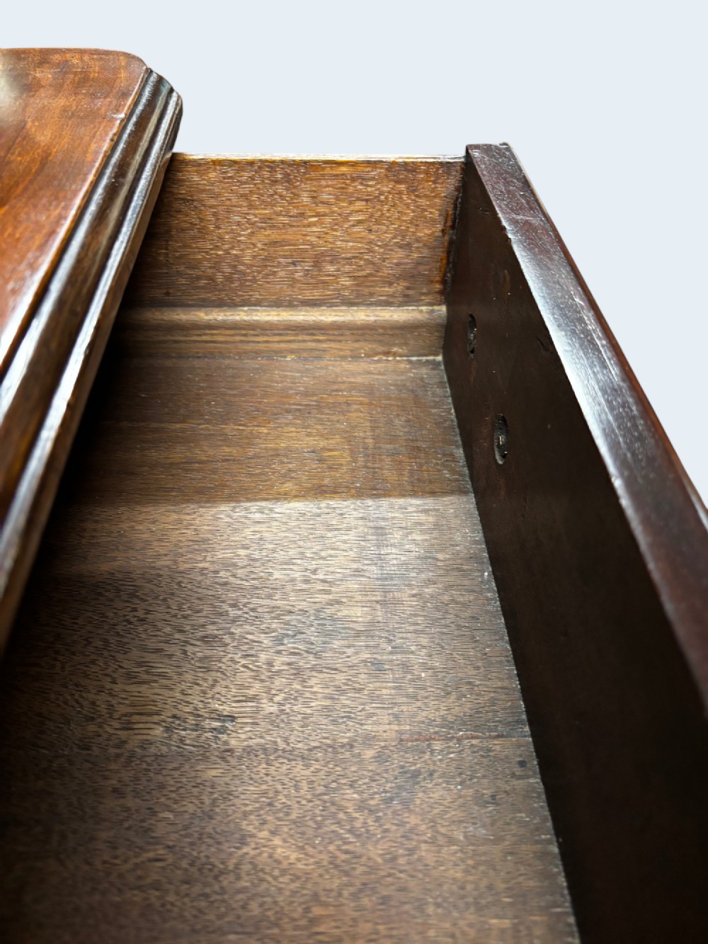 A Georgian mahogany kneehole desk with multiple drawers, brass swan-neck handles, a central recessed cupboard, and bracket feet. View VI