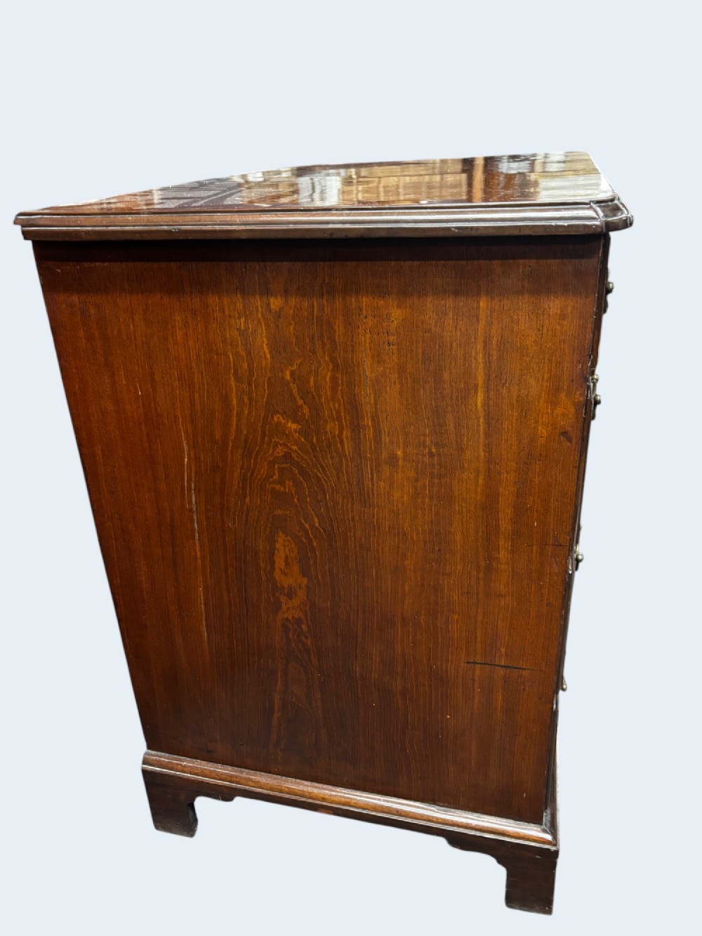 A Georgian mahogany kneehole desk with multiple drawers, brass swan-neck handles, a central recessed cupboard, and bracket feet. View VII