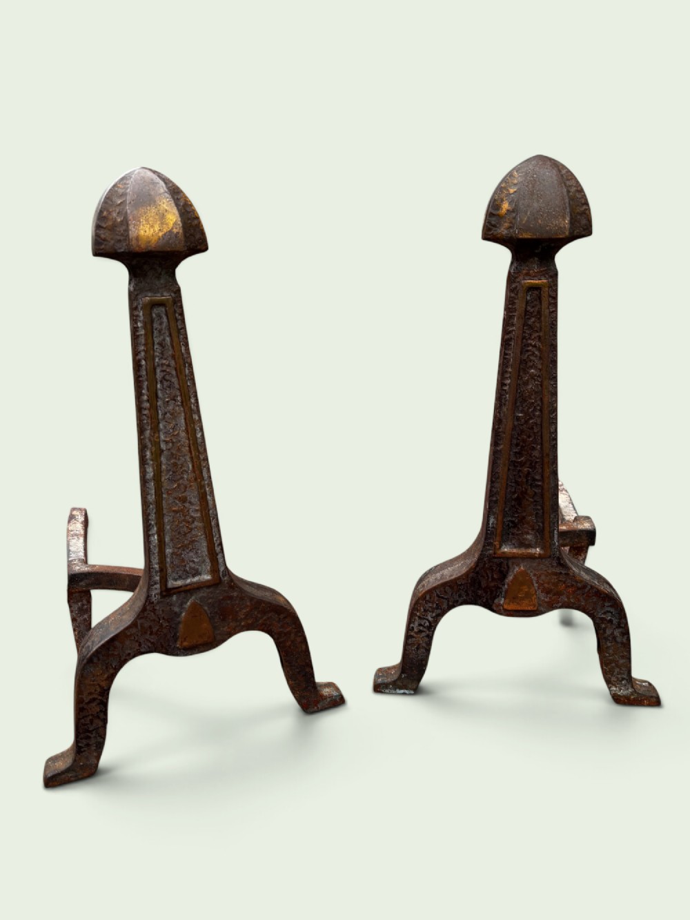 A pair of late Victorian cast iron andirons featuring textured tapered stems and pointed finials.