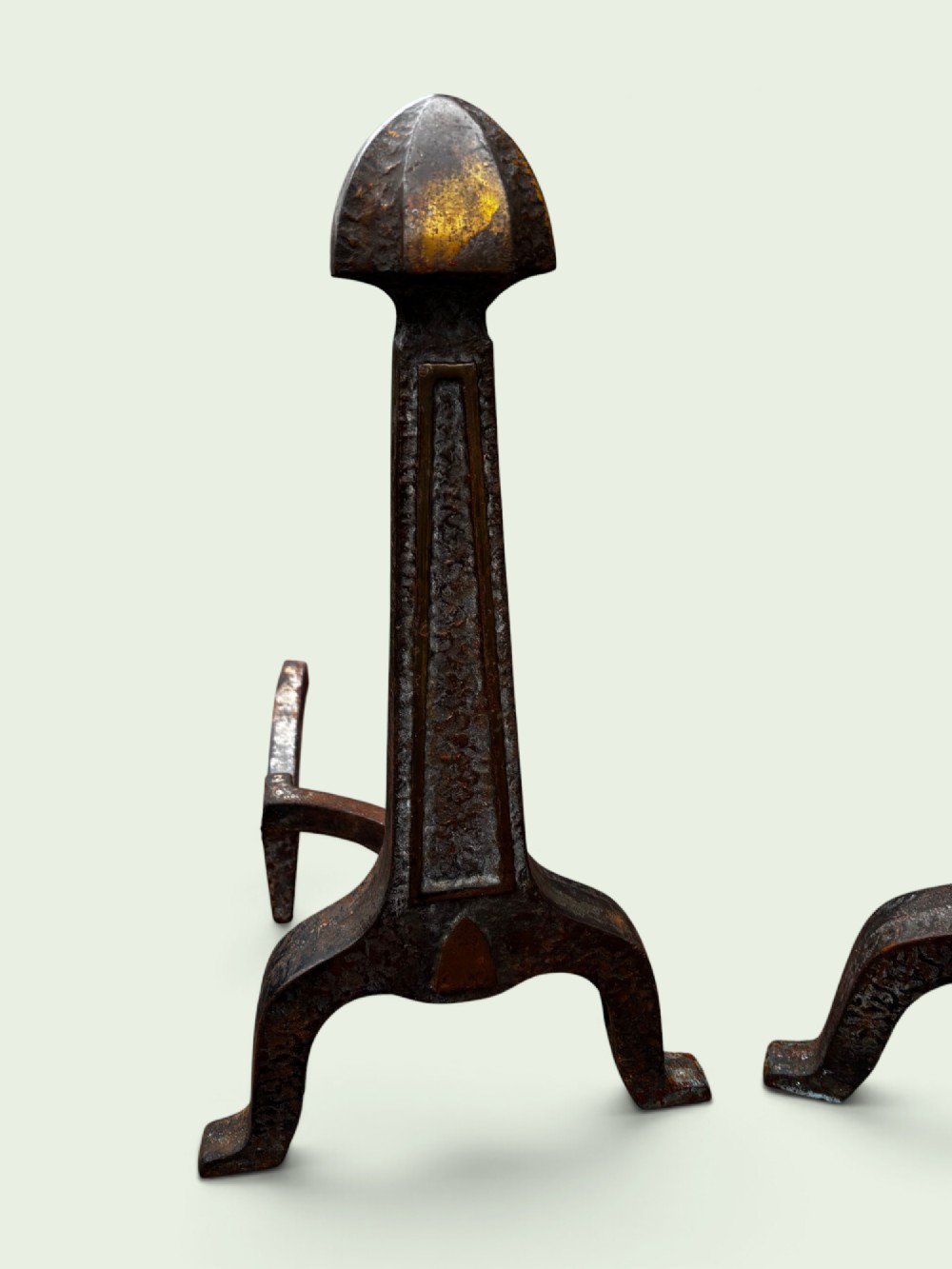 A pair of late Victorian cast iron andirons featuring textured tapered stems and pointed finials. View II