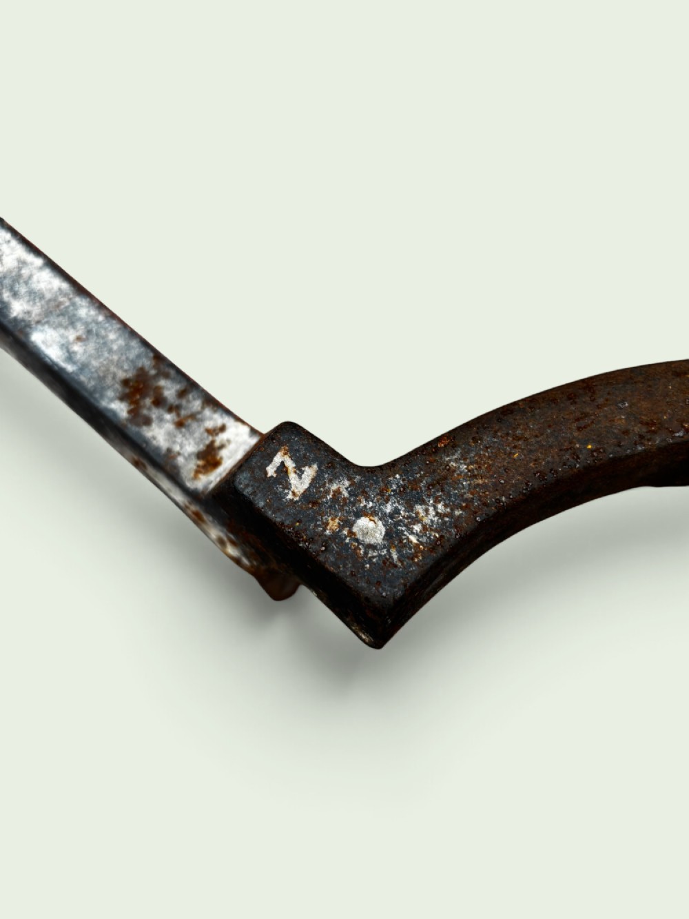 A pair of late Victorian cast iron andirons featuring textured tapered stems and pointed finials. View III