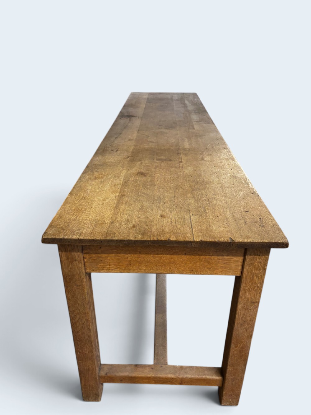 An exceptionally long rustic solid oak serving table featuring dual apron drawers, square legs, and a low central stretcher. View II