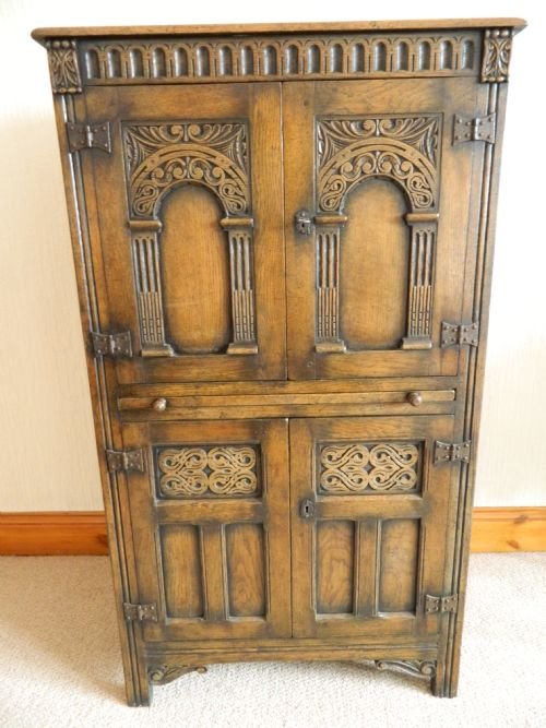 fig 1. tall carved oak cupboard