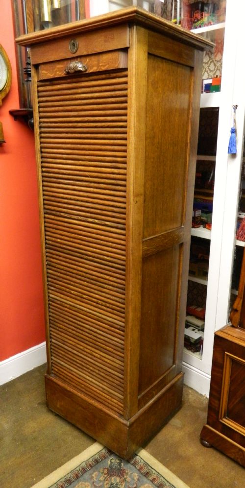 fig 1. tall oak tambour front filing cabinet