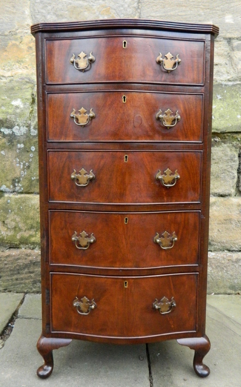 narrow mahogany serpentine chest of drawers