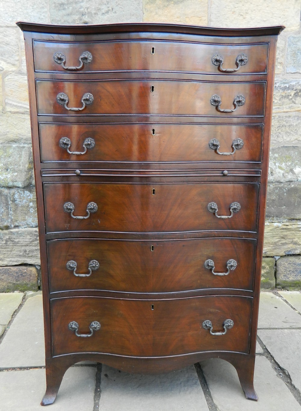 tall mahogany serpentine chest of drawers