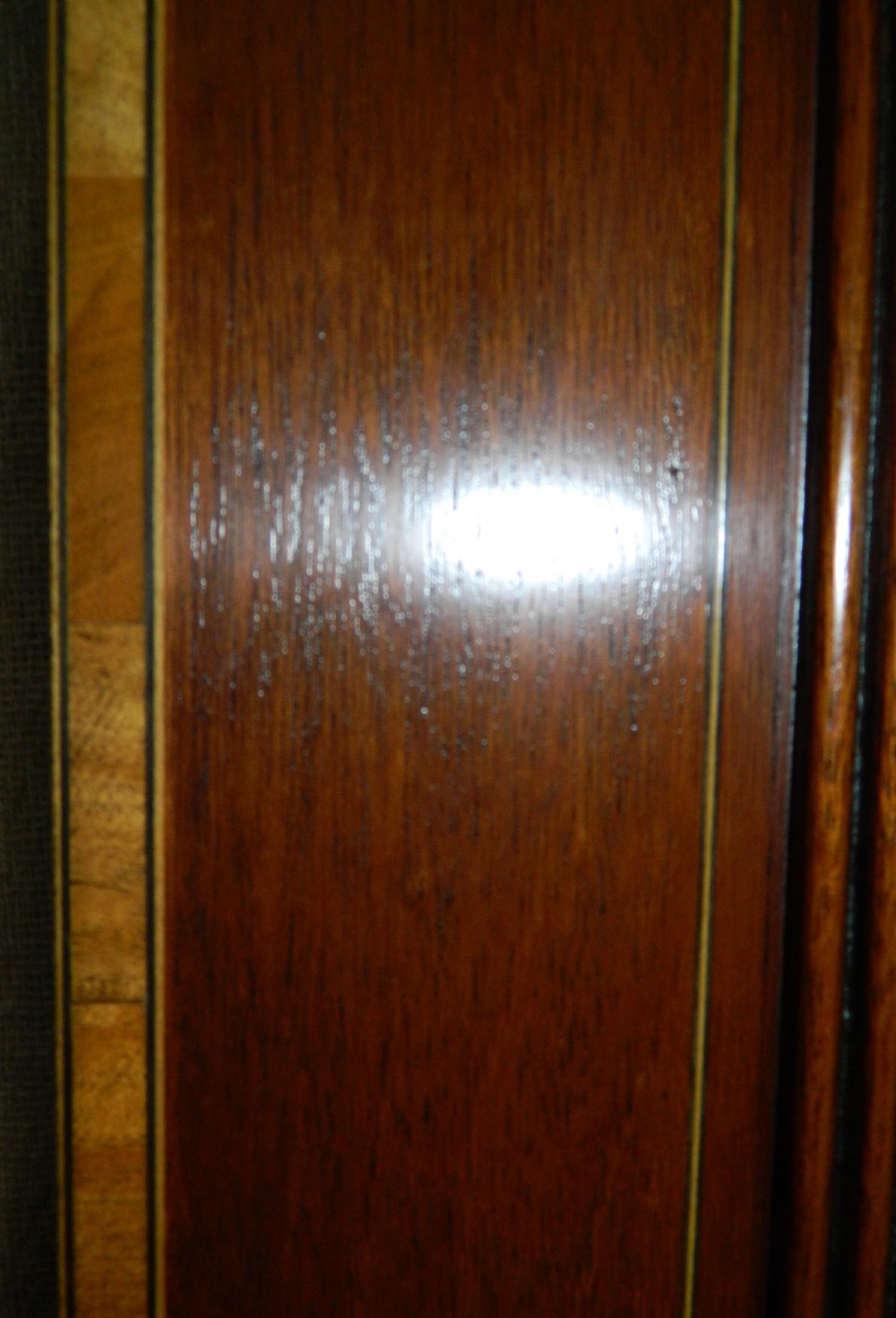 A large rectangular mirror with a gentle arched top set within a wide mahogany wood frame featuring contrasting satinwood crossbanding. View IV