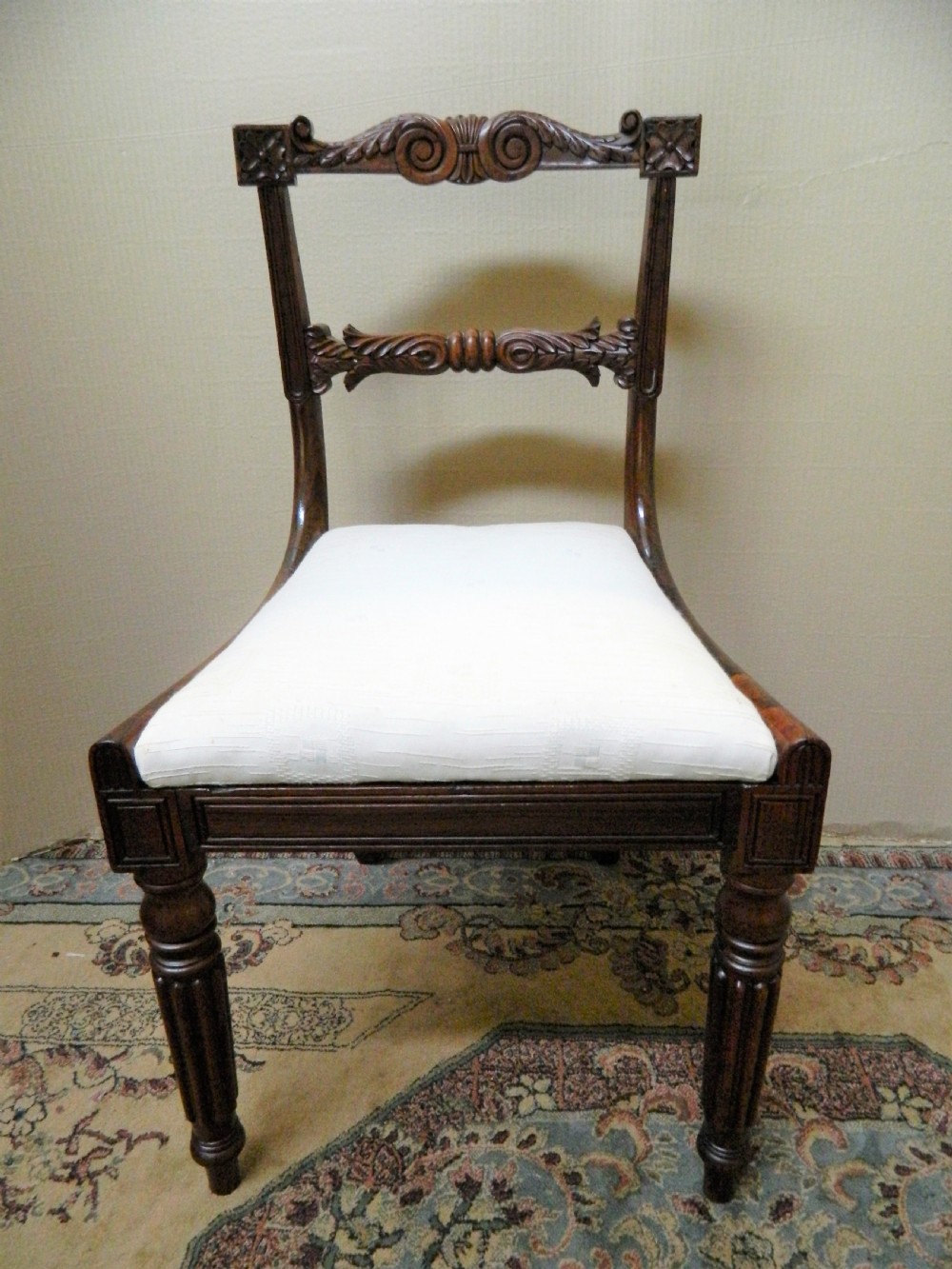 Set of six antique William IV rosewood dining chairs featuring carved scroll top rails and cream upholstered seats. View III
