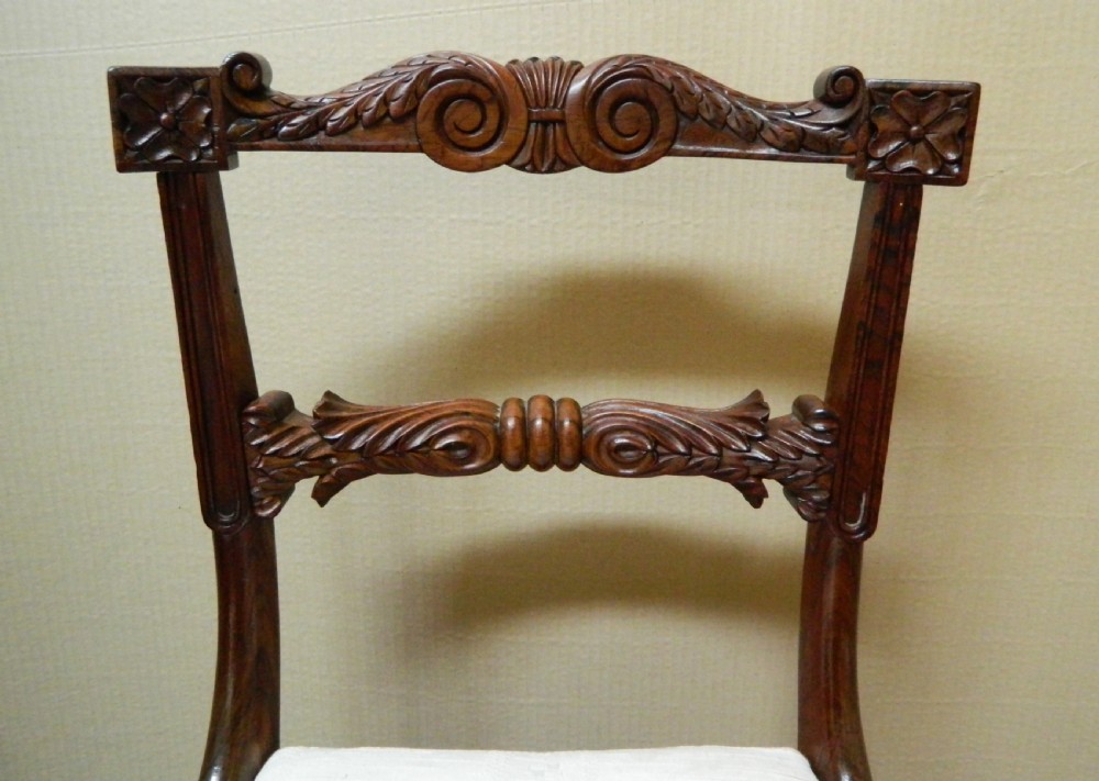 Set of six antique William IV rosewood dining chairs featuring carved scroll top rails and cream upholstered seats. View IV