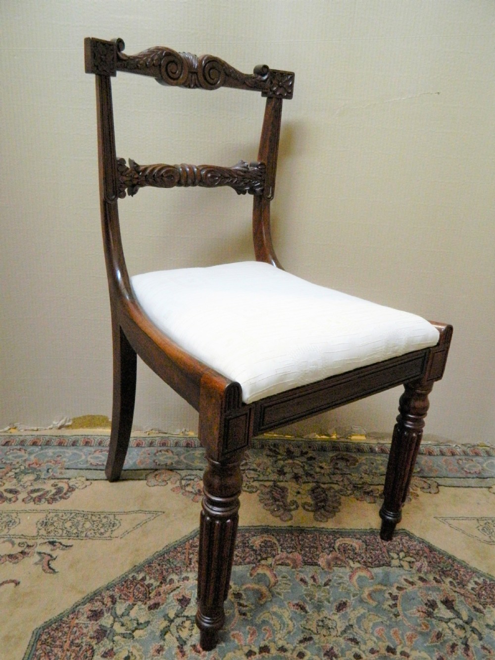 Set of six antique William IV rosewood dining chairs featuring carved scroll top rails and cream upholstered seats. View V