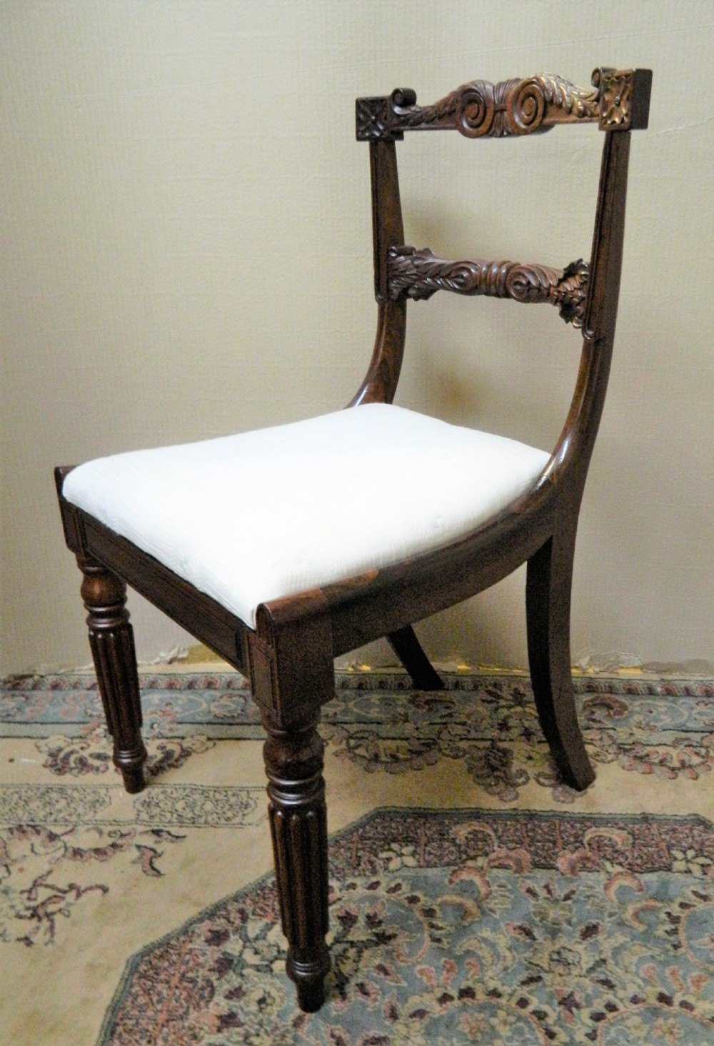 Set of six antique William IV rosewood dining chairs featuring carved scroll top rails and cream upholstered seats. View VI