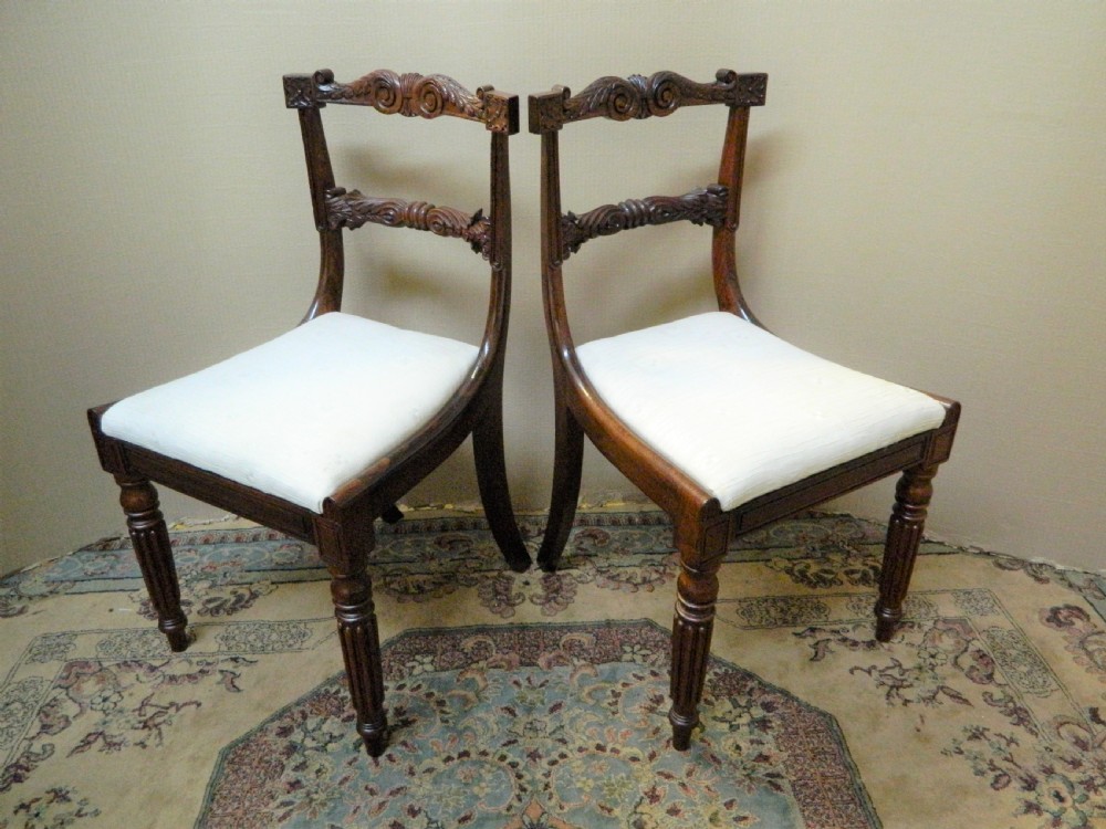 Set of six antique William IV rosewood dining chairs featuring carved scroll top rails and cream upholstered seats. View VIII