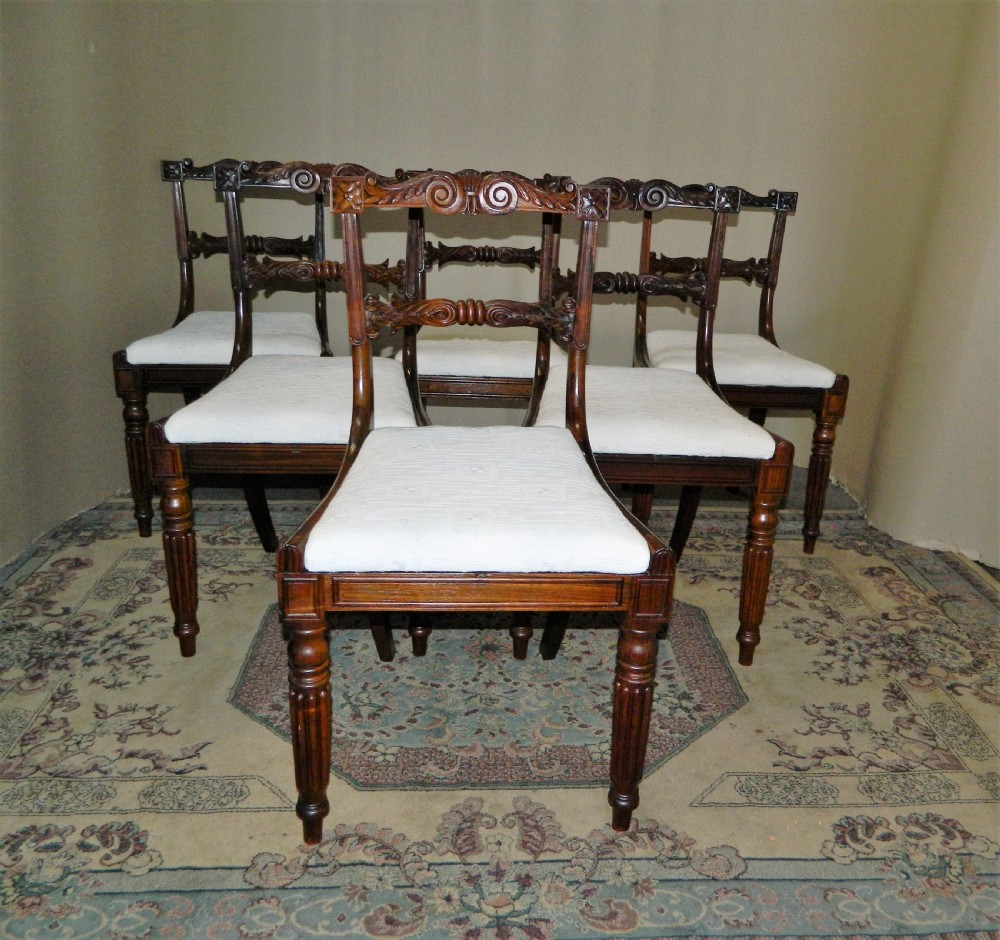Set of six antique William IV rosewood dining chairs featuring carved scroll top rails and cream upholstered seats. View IX