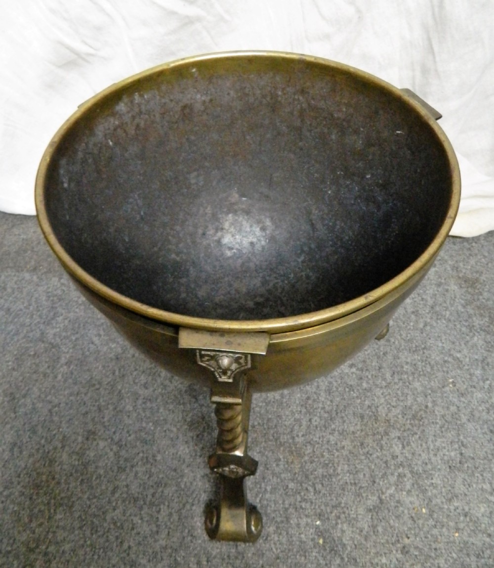 An Arts and Crafts period brass coal bin featuring a domed removable lid, top handle, and three twisted spiral legs on tripod feet. View III