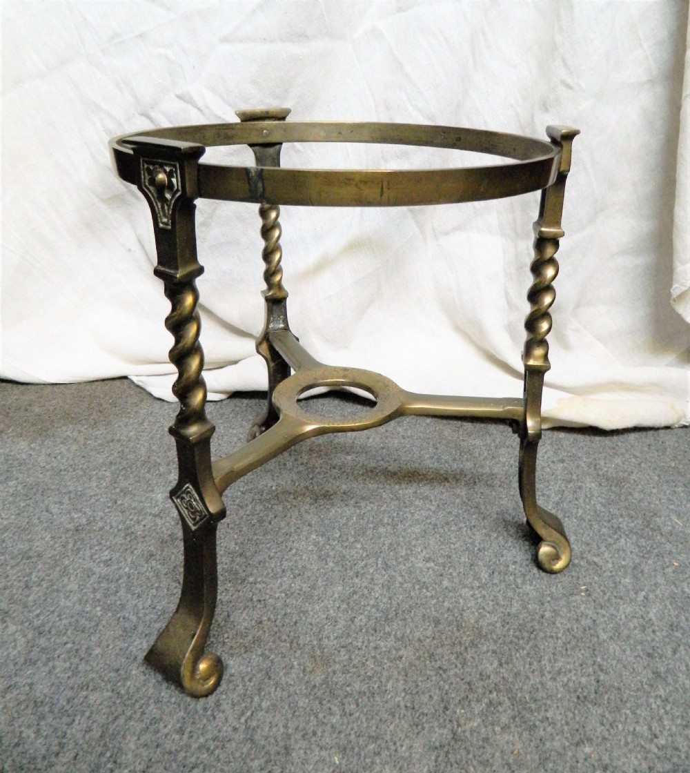 An Arts and Crafts period brass coal bin featuring a domed removable lid, top handle, and three twisted spiral legs on tripod feet. View V