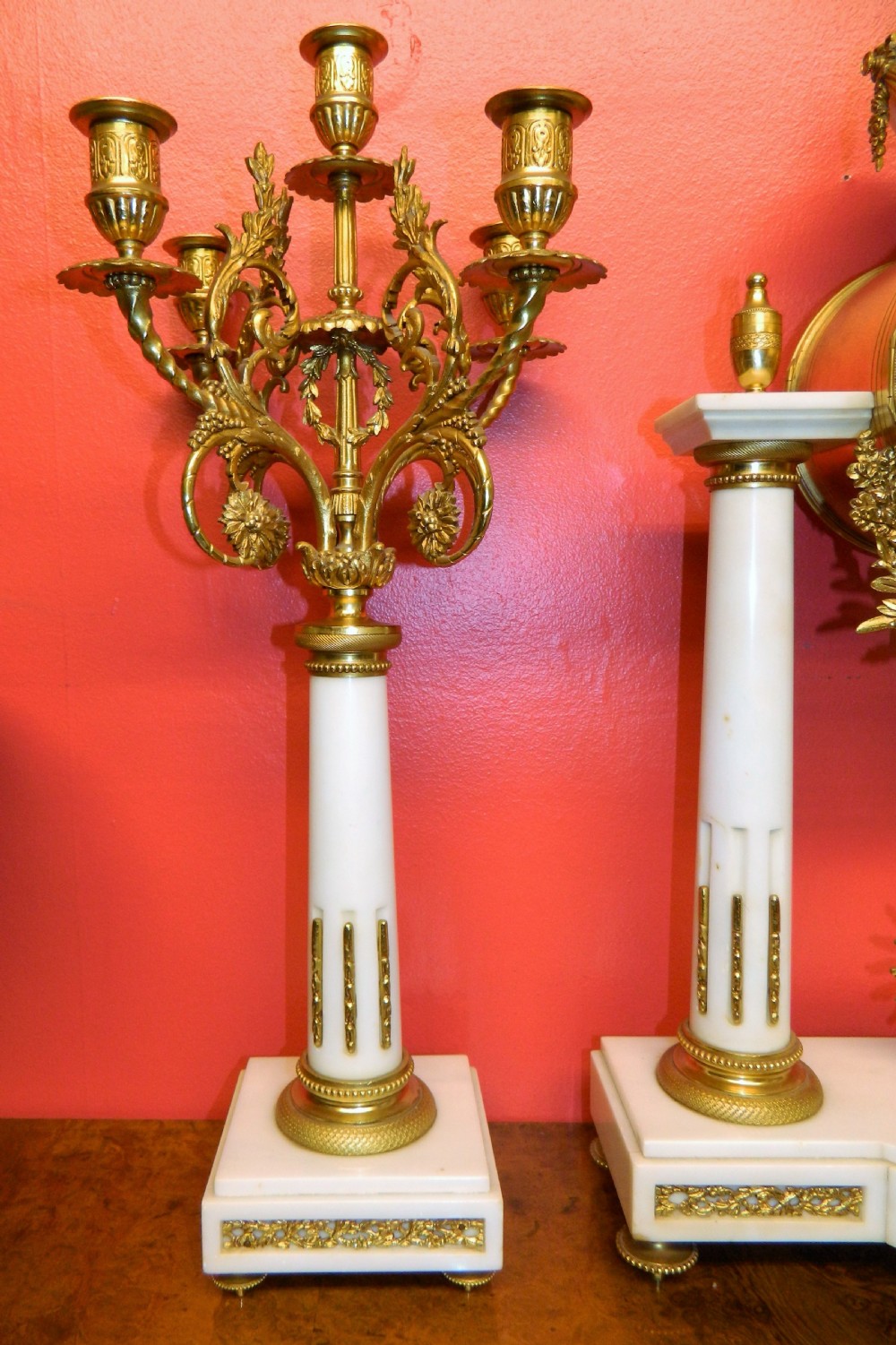 A French Neoclassical white marble and gilt ormolu portico mantel clock flanked by two matching five-light candelabra. View IX