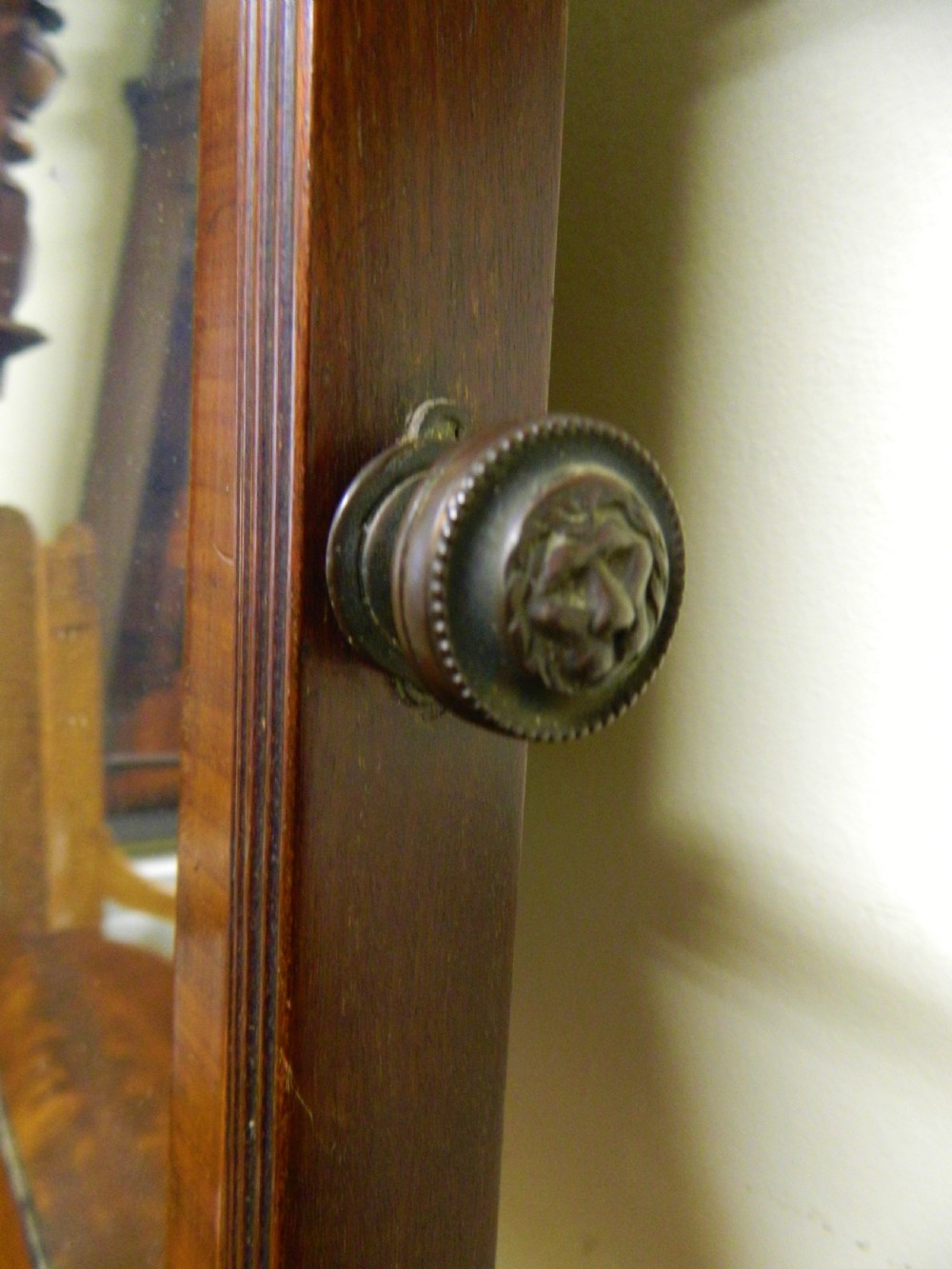 An antique mahogany toilet mirror featuring a swivelling arched glass frame mounted on a base with two inlaid drawers. View VI