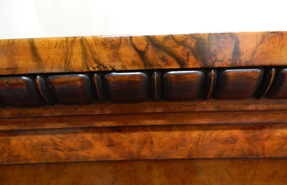 A large Victorian burr walnut bookcase featuring four glass-panelled doors, detailed wood grain patterning, and a solid plinth base. View VIII