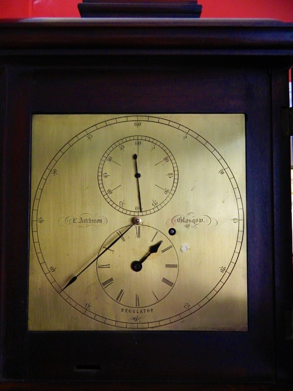 A Victorian dark mahogany regulator longcase clock featuring a silvered regulator dial, glazed trunk door showing the pendulum, and a stepped pediment. View II