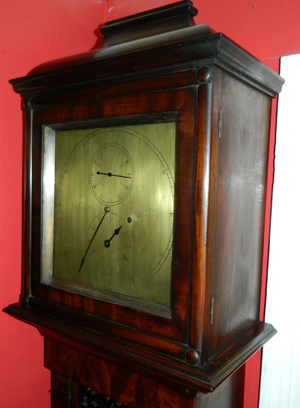 A Victorian dark mahogany regulator longcase clock featuring a silvered regulator dial, glazed trunk door showing the pendulum, and a stepped pediment. View VI