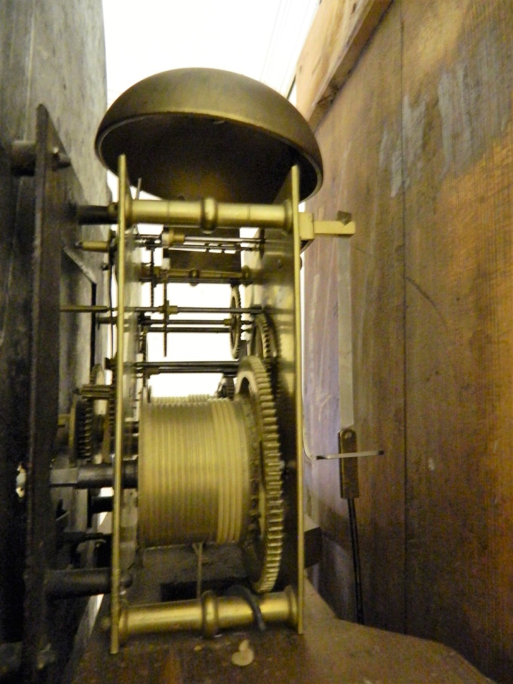 An antique Georgian mahogany longcase clock featuring a swan-neck pediment with brass finials, a painted arch dial, and string inlay details. View IX