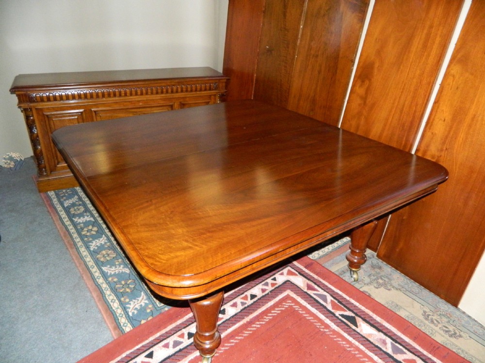 Large mahogany dining table with leaf carrier