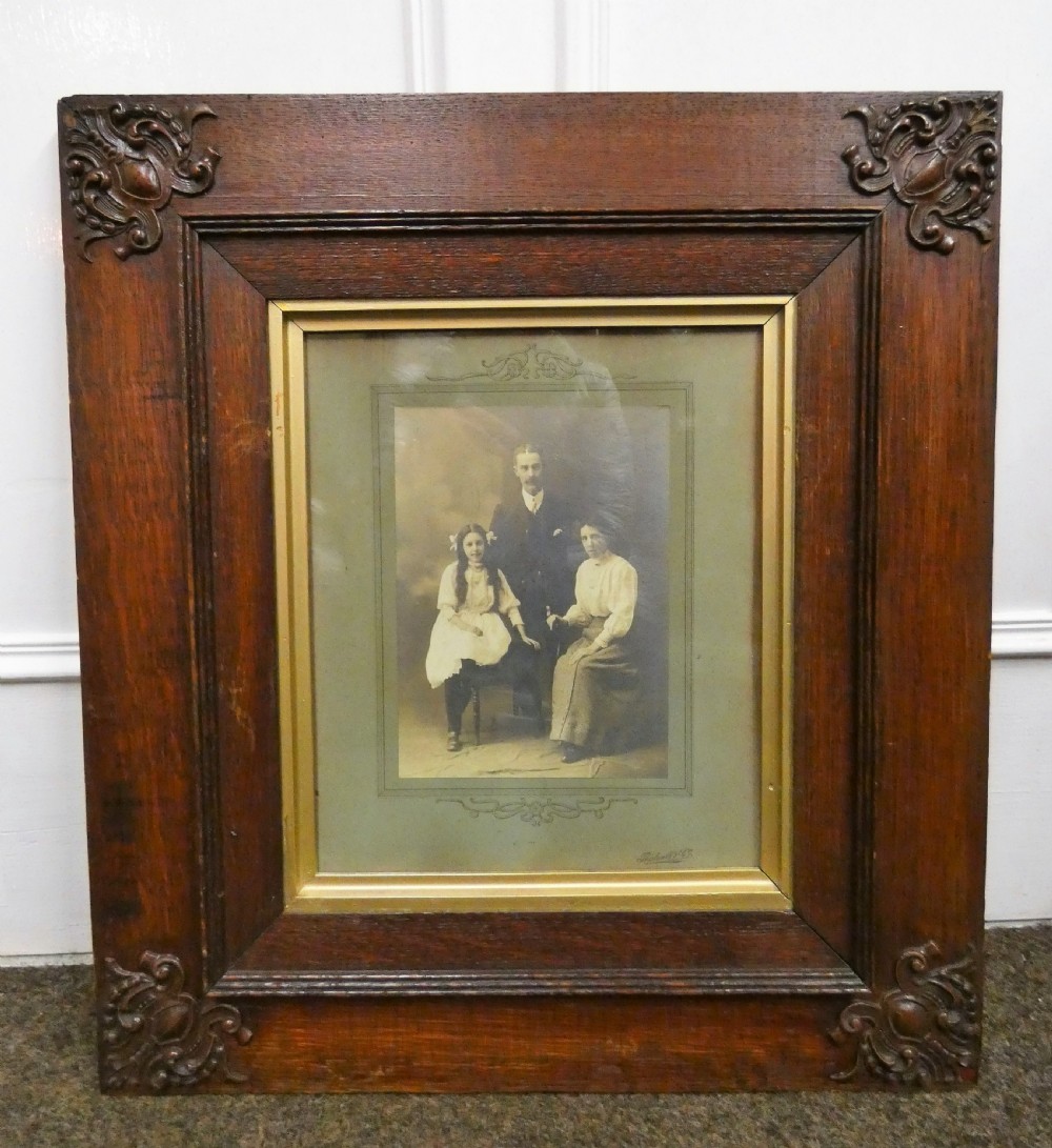 Pair of antique framed sepia family portraits housed within carved dark oak frames featuring inner gold gilt borders. View II